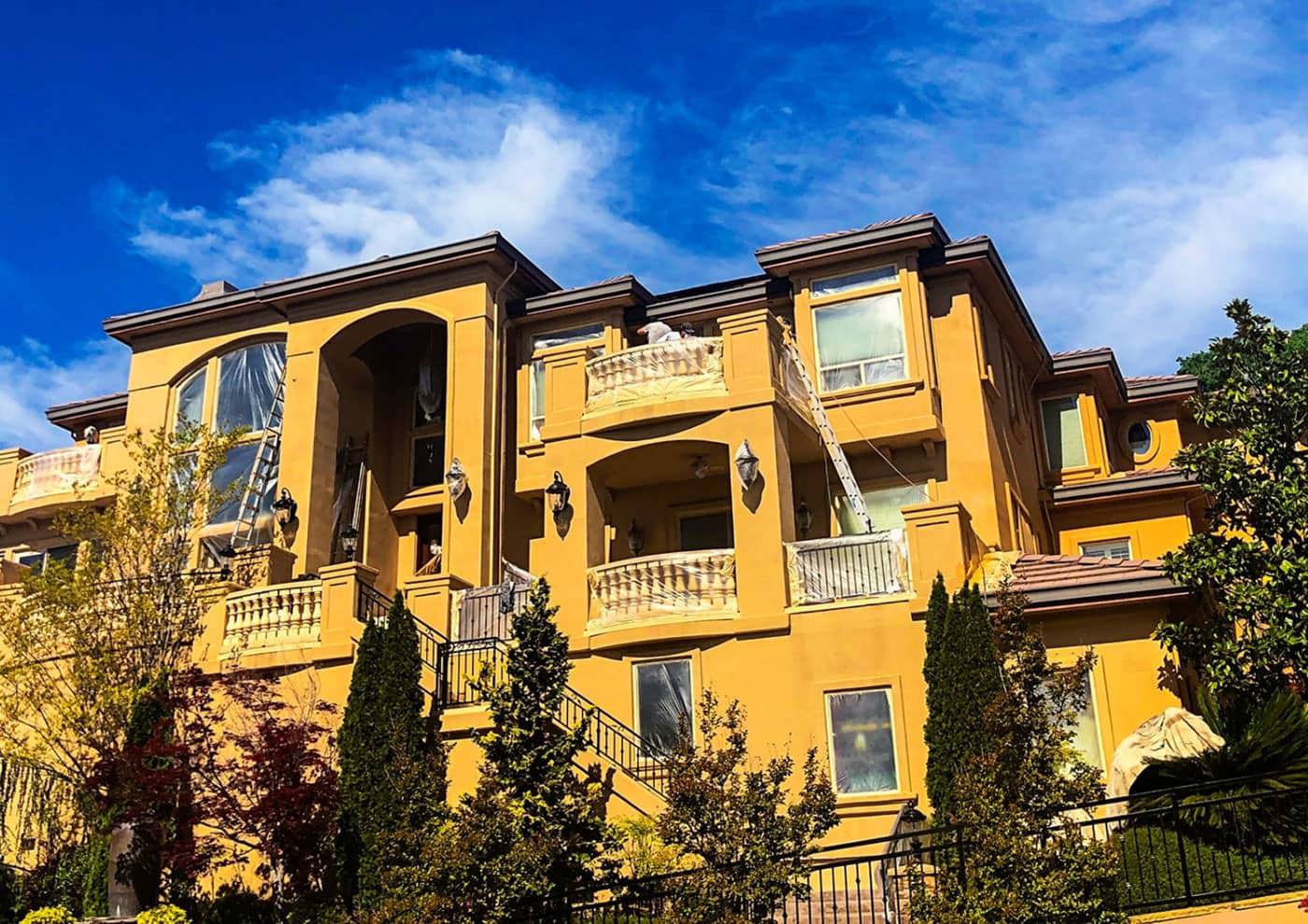 house being painted yellow